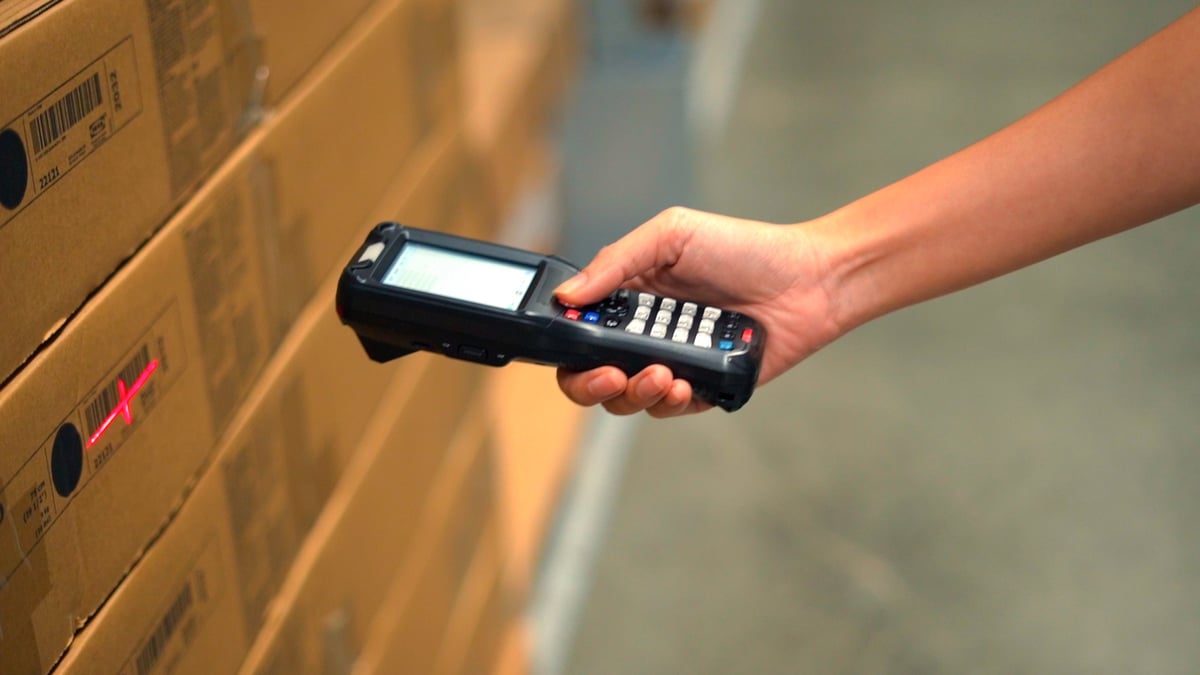 Hand scanning a product label with a barcode scanner