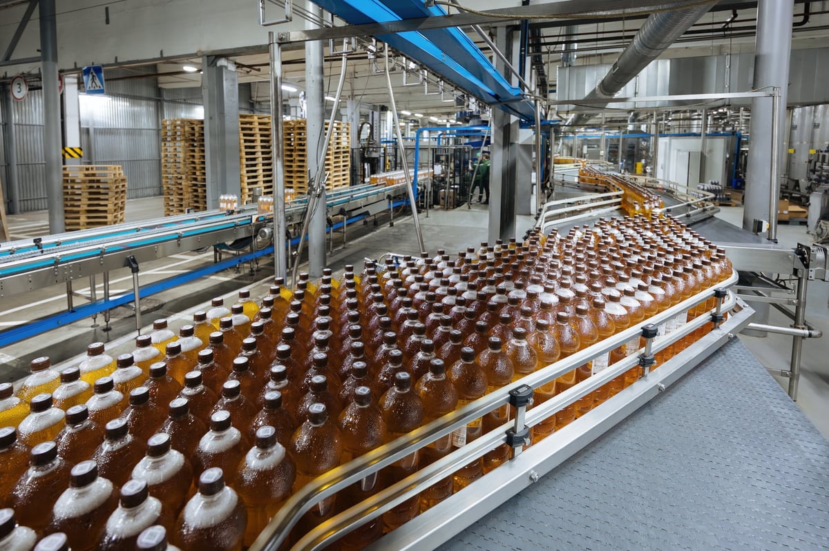 Production line bottling beverages into plastic bottles and packing them for distribution