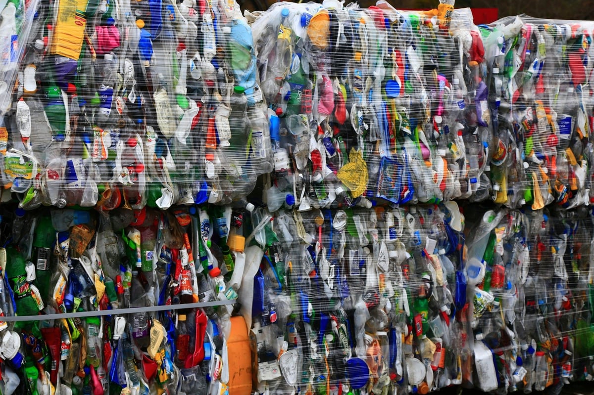 Compressed bales of used plastic containers showing a mixture of colours and packaging types