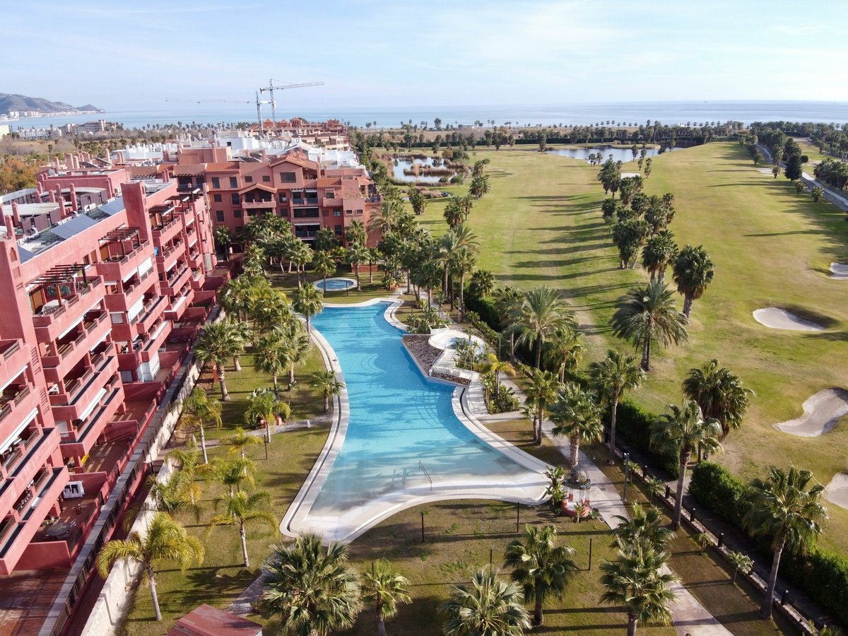 Coastal accommodation, a swimming pool and golf course in Playa Granada, Spain