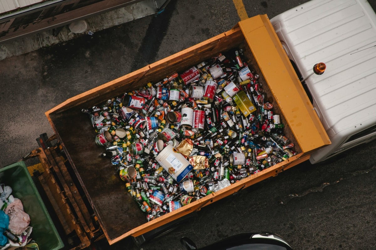 Overhead view of a collection truck carrying mixed used cans and containers