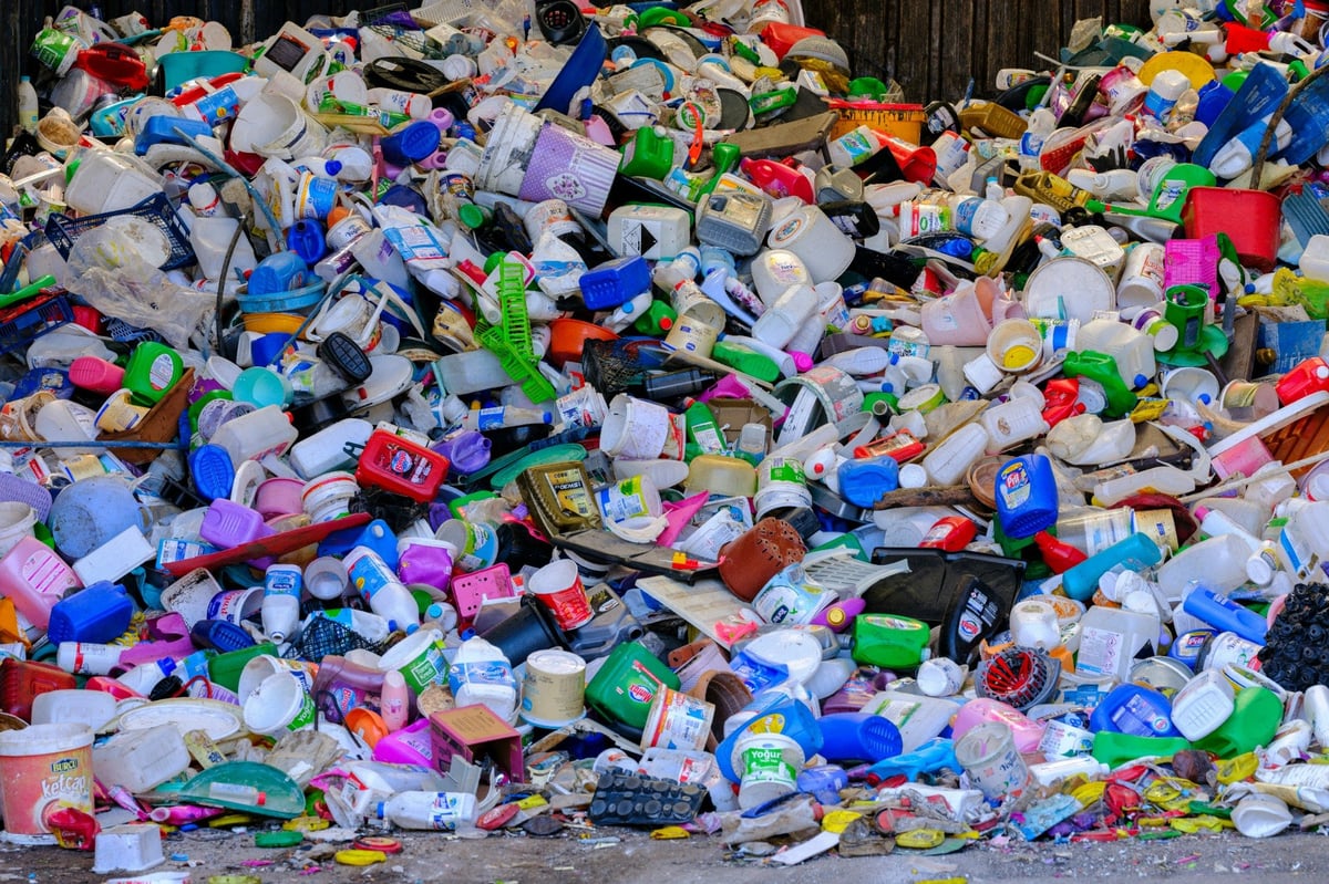 Mixed used plastic containers, buckets and household items awaiting sorting