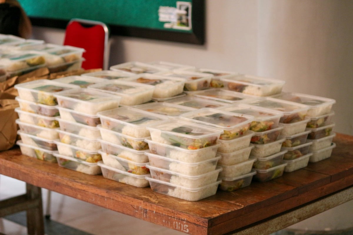 Prepared meals stacked in clear lidded plastic containers