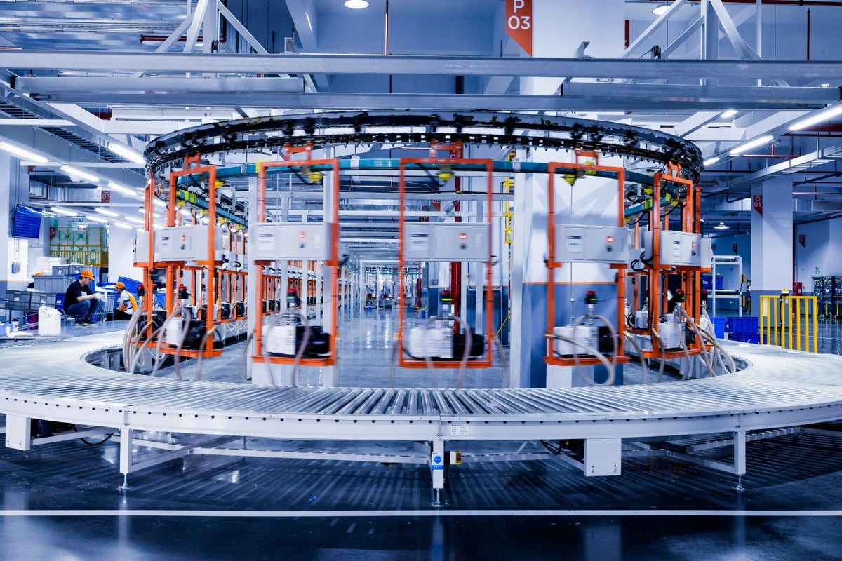 Factory production equipment arranged around a curved conveyor line