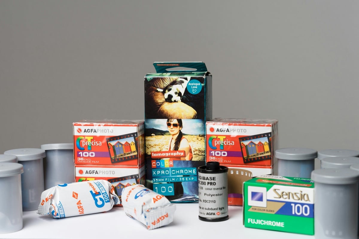 Photographic film in a mixture of cardboard boxes, wrappers and plastic canisters